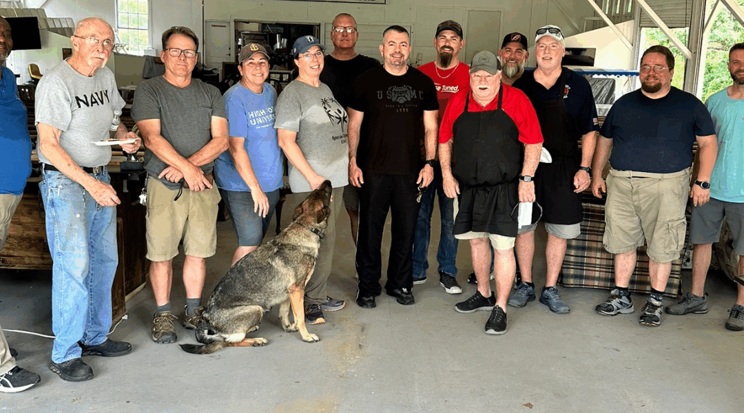 Group of veterans and volunteers standing together at The Heroes Center in High Point, North Carolina, symbolizing community support and collaboration