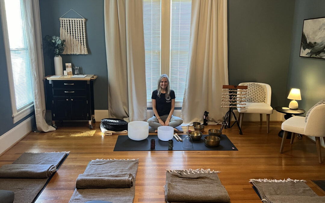 Veda Spidle sits in front of singing bowls